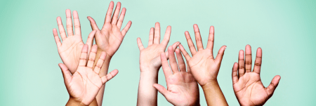 Multiple hands raised in the air